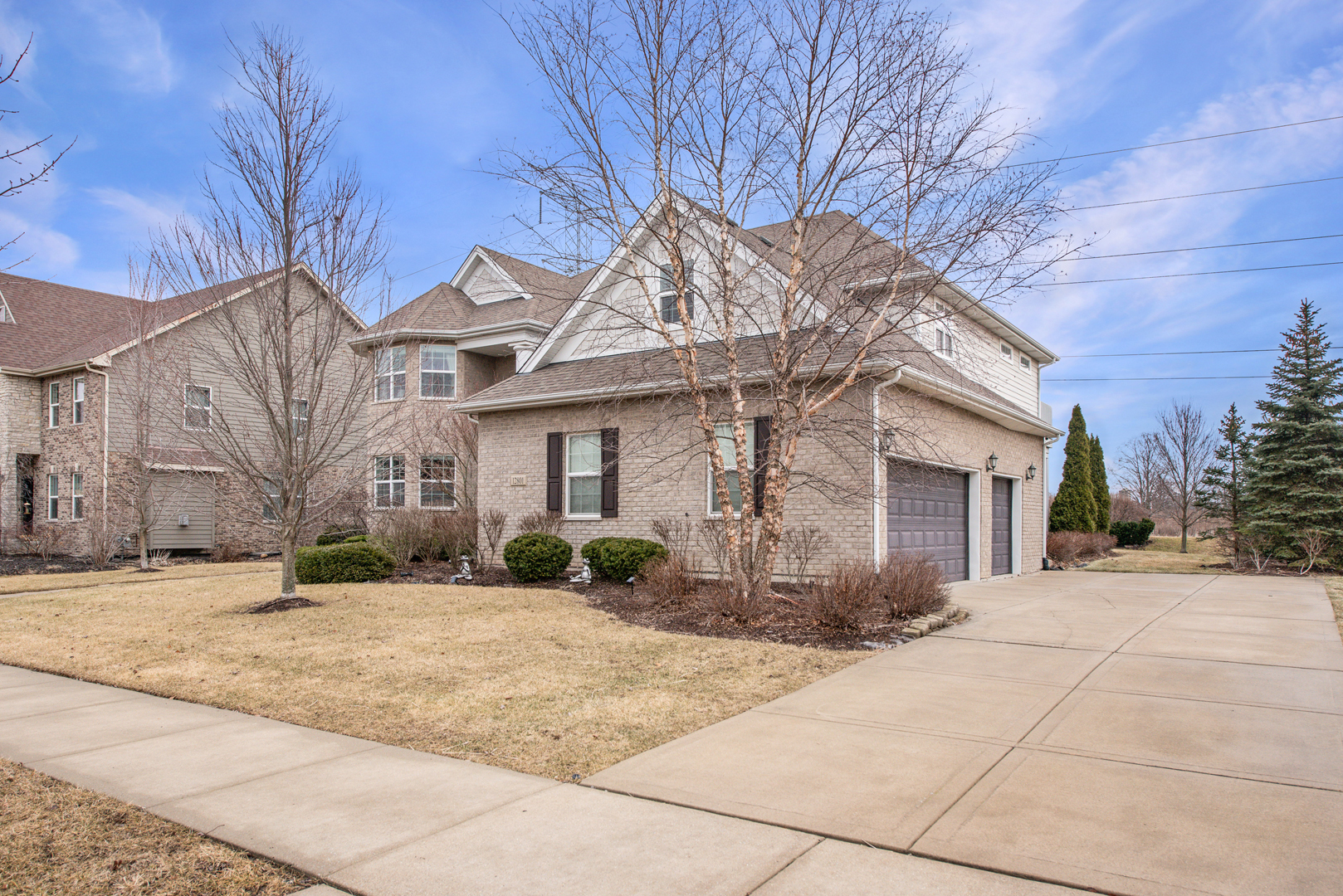 12801 Dunmoor Drive Lemont, IL 60439 - Photo 2 of 4 a front view of a house with a yard and garage