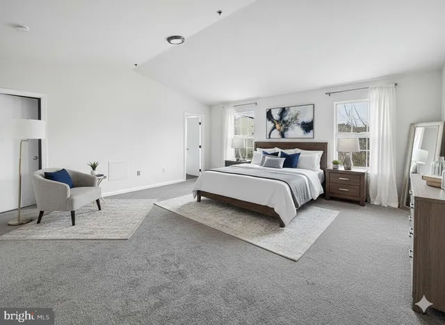 a spacious bedroom with a bed and a couch