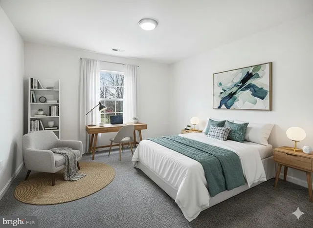 a bedroom with a bed and a couch