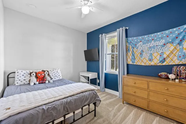 a bedroom with a bed and dresser