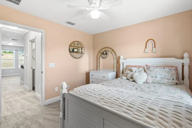 a bedroom with a large bed and a chandelier