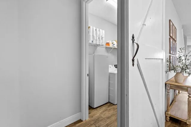 a view of hallway with wooden floor and stairs