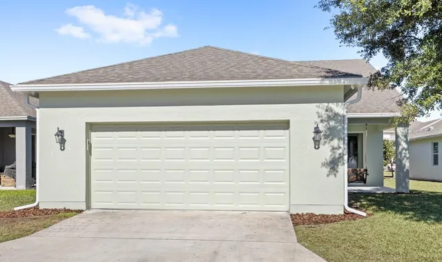 a backyard of a house with yard and garage