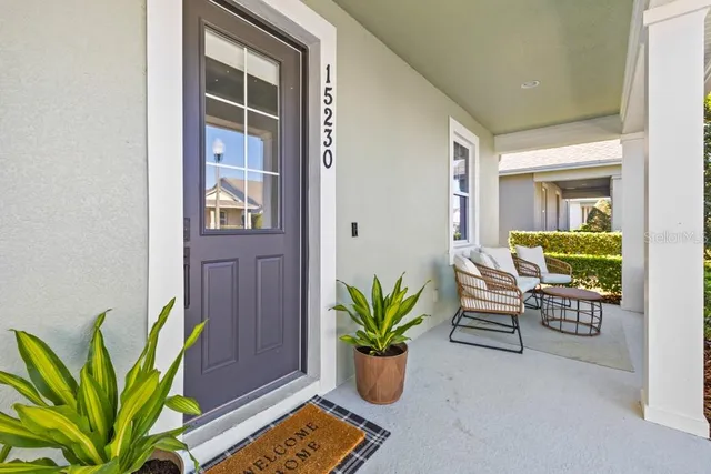 a dining room with furniture and a potted plant
