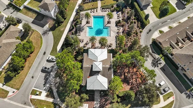 an aerial view of a house with garden space and street view