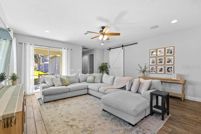 a living room with furniture and wooden floor