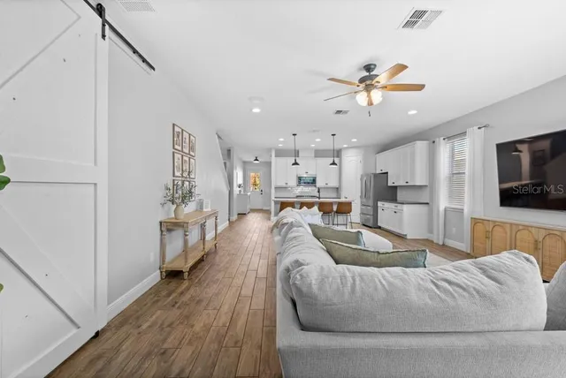 a living room with furniture and a flat screen tv