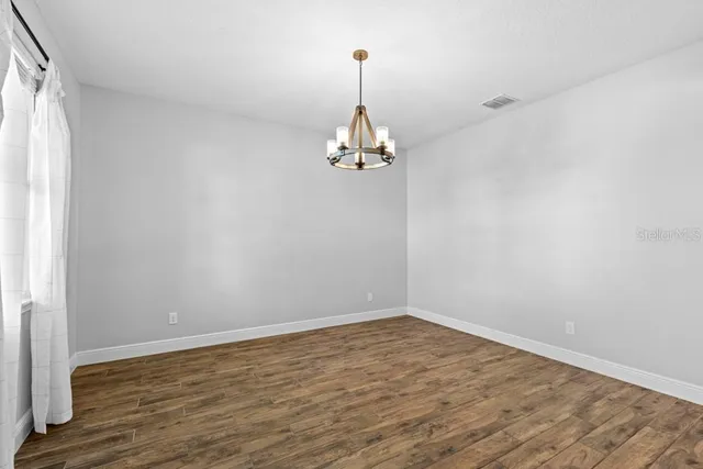 a room with a window and a chandelier