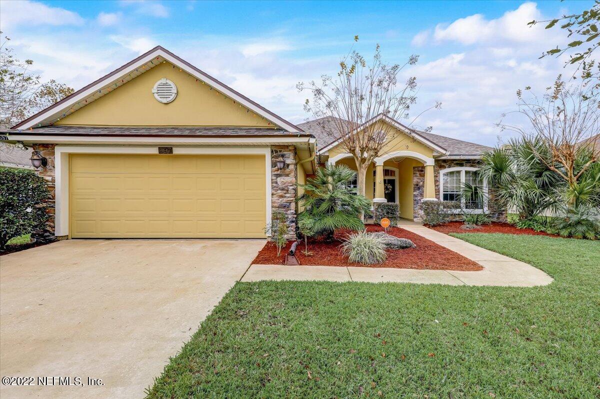697 Porta Rosa Circle St. Augustine, FL 32092 - Photo 1 of 43 a front view of a house with a yard and garage