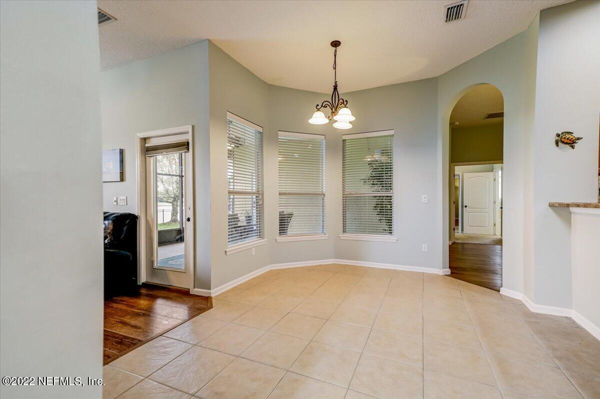 697 Porta Rosa Circle St. Augustine, FL 32092 - Photo 12 of 43 a view of an empty room with chandelier and glass door