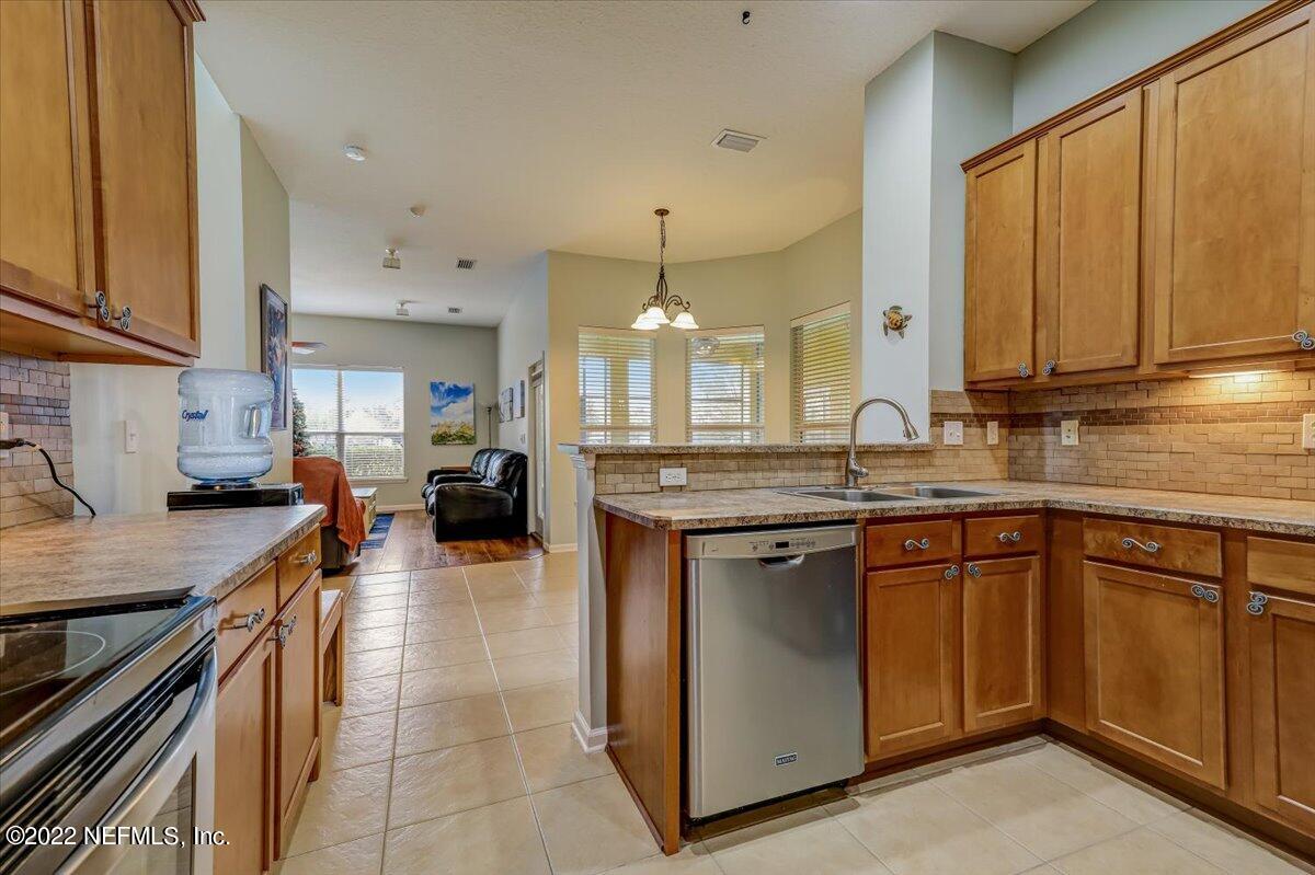 697 Porta Rosa Circle St. Augustine, FL 32092 - Photo 15 of 43 a kitchen with stainless steel appliances granite countertop a stove a sink dishwasher and a refrigerator
