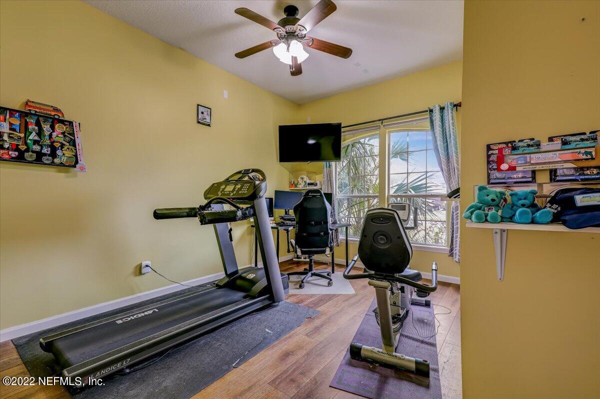 697 Porta Rosa Circle St. Augustine, FL 32092 - Photo 16 of 43 a room with gym equipment and a flat screen tv