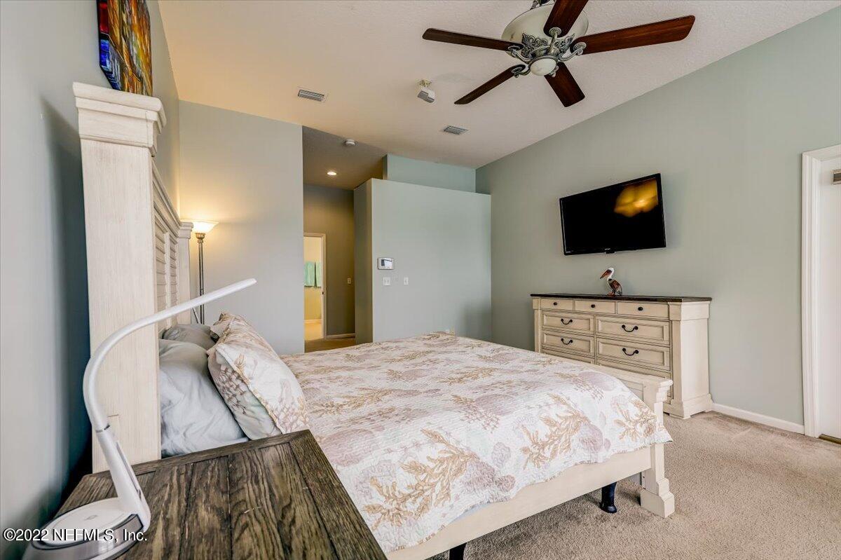 697 Porta Rosa Circle St. Augustine, FL 32092 - Photo 19 of 43 a bedroom with a bed and a flat screen tv