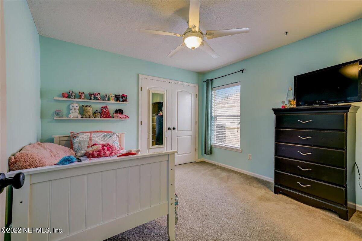 697 Porta Rosa Circle St. Augustine, FL 32092 - Photo 24 of 43 a living room with furniture and a flat screen tv
