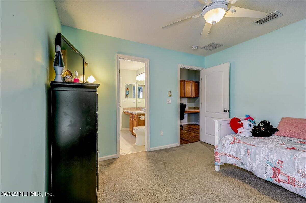 697 Porta Rosa Circle St. Augustine, FL 32092 - Photo 25 of 43 a bedroom with bed and cabinets