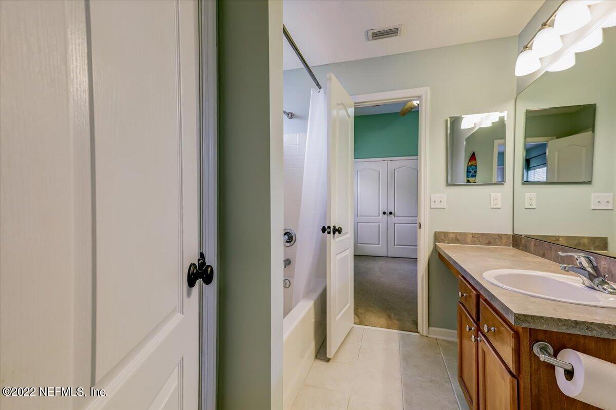 697 Porta Rosa Circle St. Augustine, FL 32092 - Photo 26 of 43 a bathroom with a sink a vanity and shower