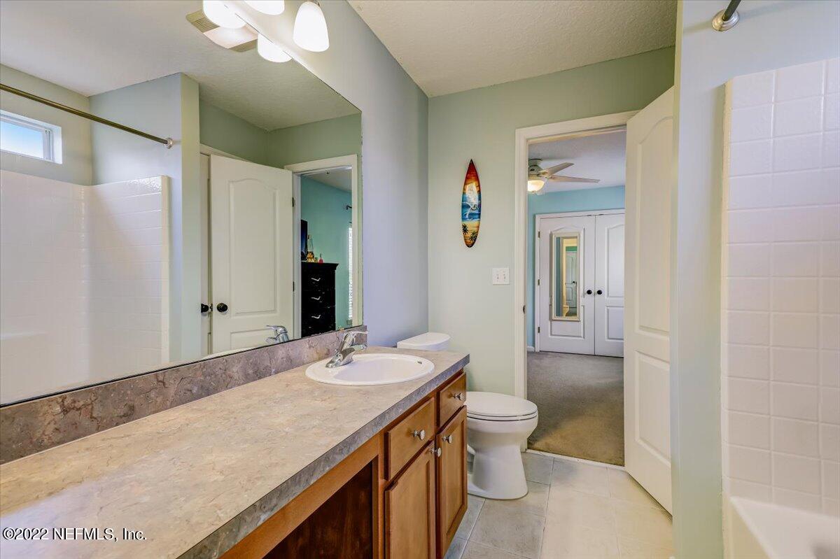 697 Porta Rosa Circle St. Augustine, FL 32092 - Photo 27 of 43 a bathroom with a sink a toilet and a large mirror