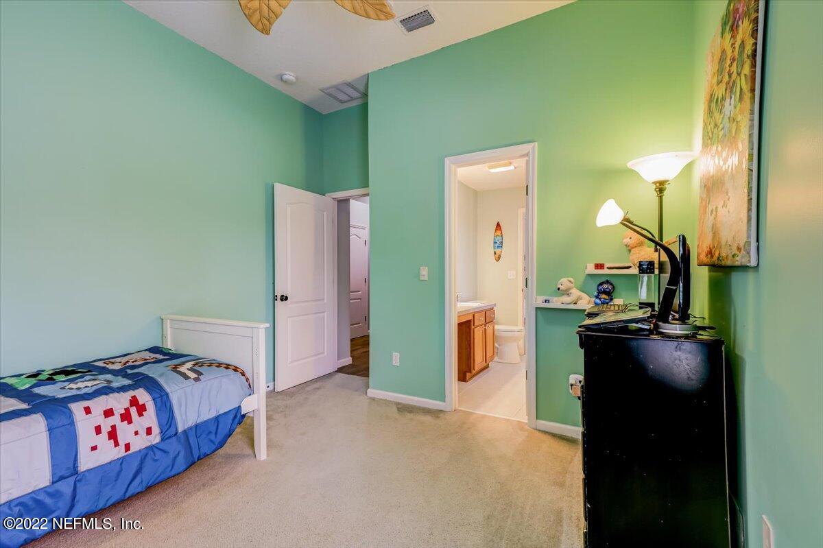 697 Porta Rosa Circle St. Augustine, FL 32092 - Photo 29 of 43 a bedroom with a bed and a dresser