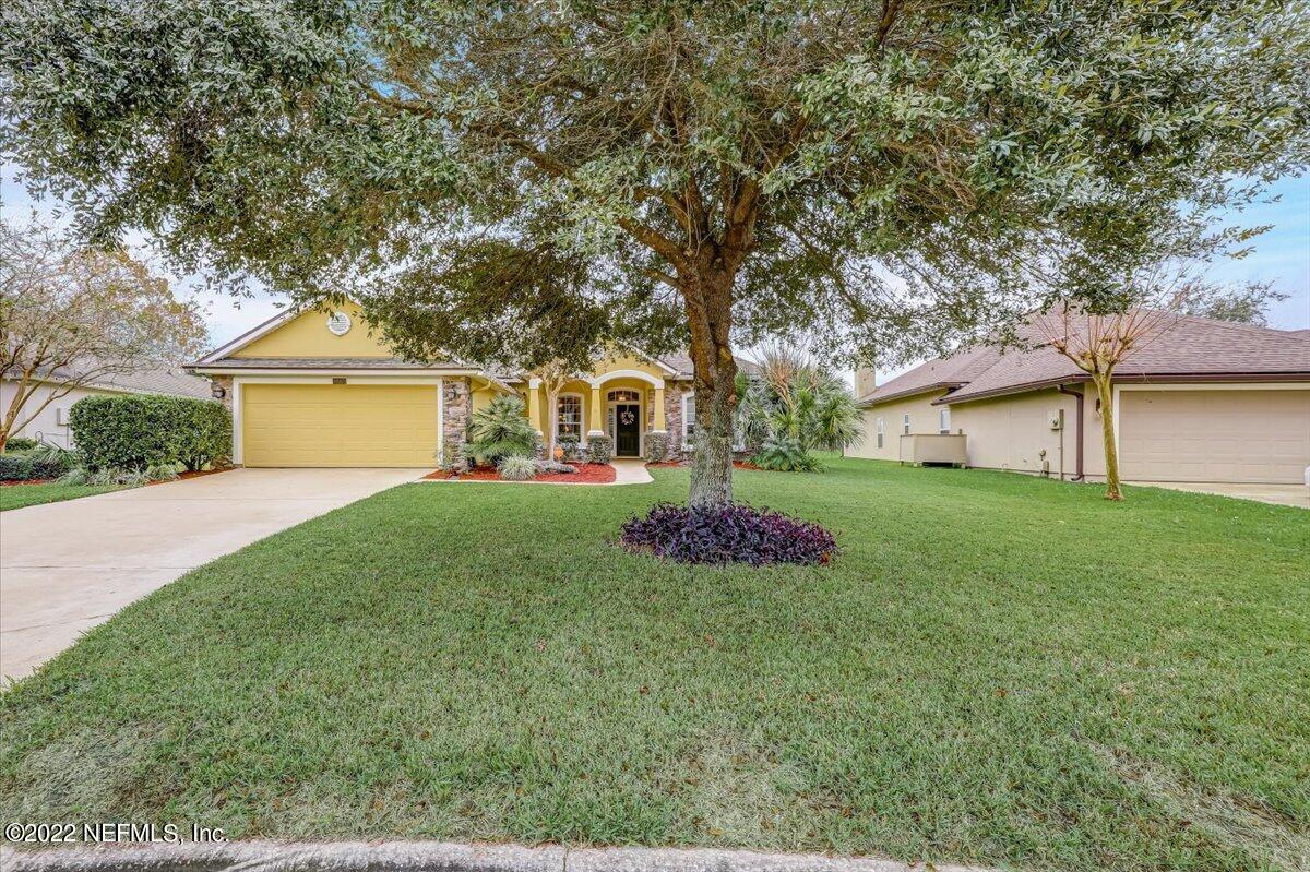 697 Porta Rosa Circle St. Augustine, FL 32092 - Photo 3 of 43 a front view of a house with a yard and garage