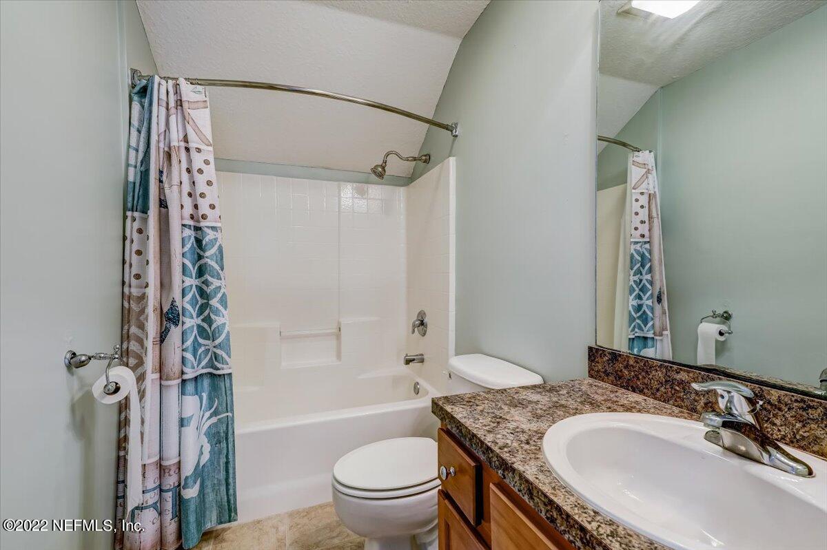 697 Porta Rosa Circle St. Augustine, FL 32092 - Photo 32 of 43 a bathroom with a granite countertop sink toilet and shower