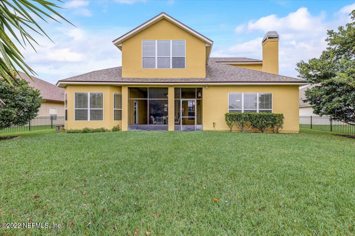 697 Porta Rosa Circle St. Augustine, FL 32092 - Photo 34 of 43 a view of a house with a yard and plants