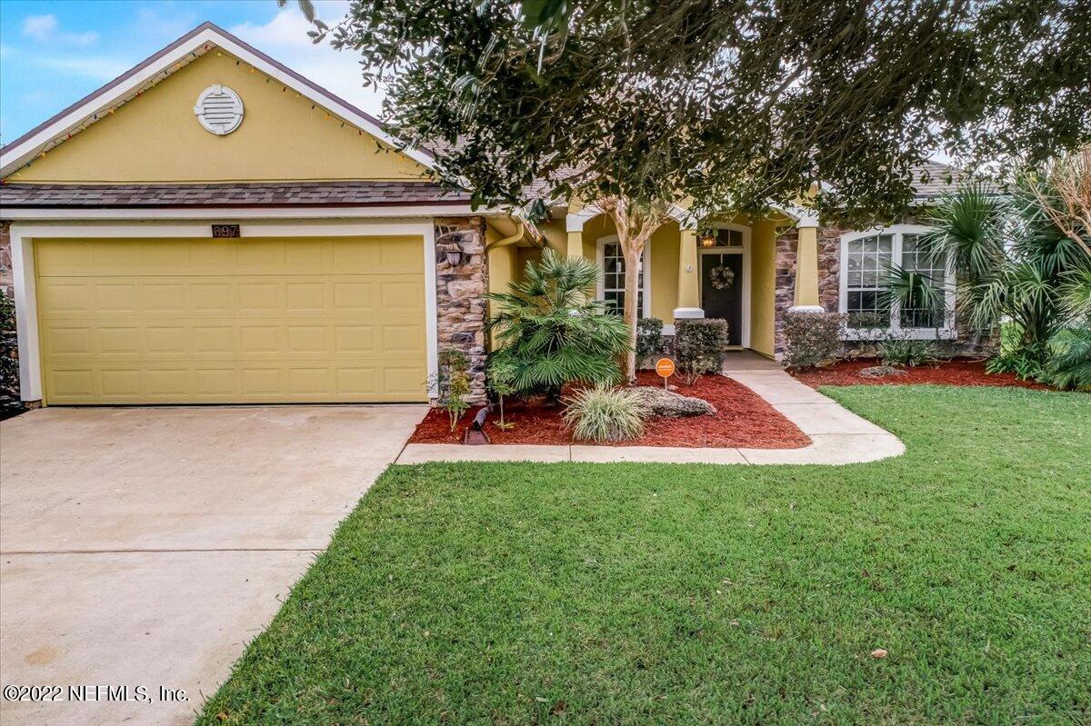 697 Porta Rosa Circle St. Augustine, FL 32092 - Photo 35 of 43 a view of a house with a yard patio and a tree