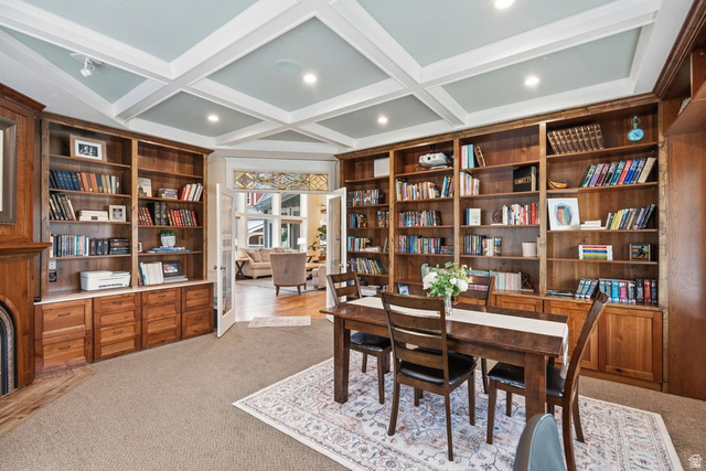 672 Perry Hollow Drive Mapleton, UT 84664 - Photo 20 of 106 Built-in wood cabinetry and shelving frame the room, complemented by a coffered ceiling with recessed lighting