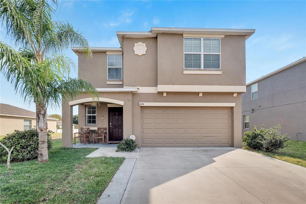 a front view of house with yard and outdoor seating