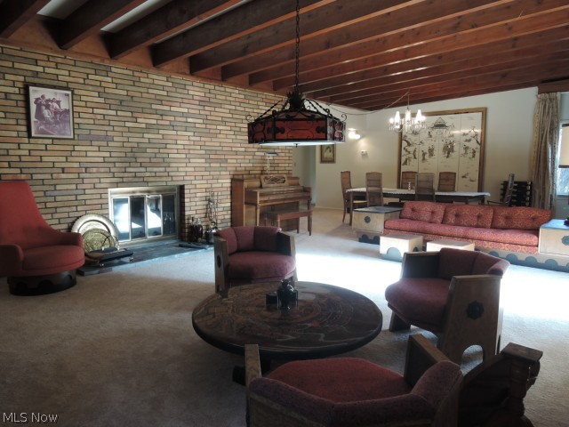 13091 County Line Road Chesterland, OH 44026 - Photo 2 of 23 Newer neutral carpet (2014) in this living room dining room combination with a beautiful beamed ceiling.