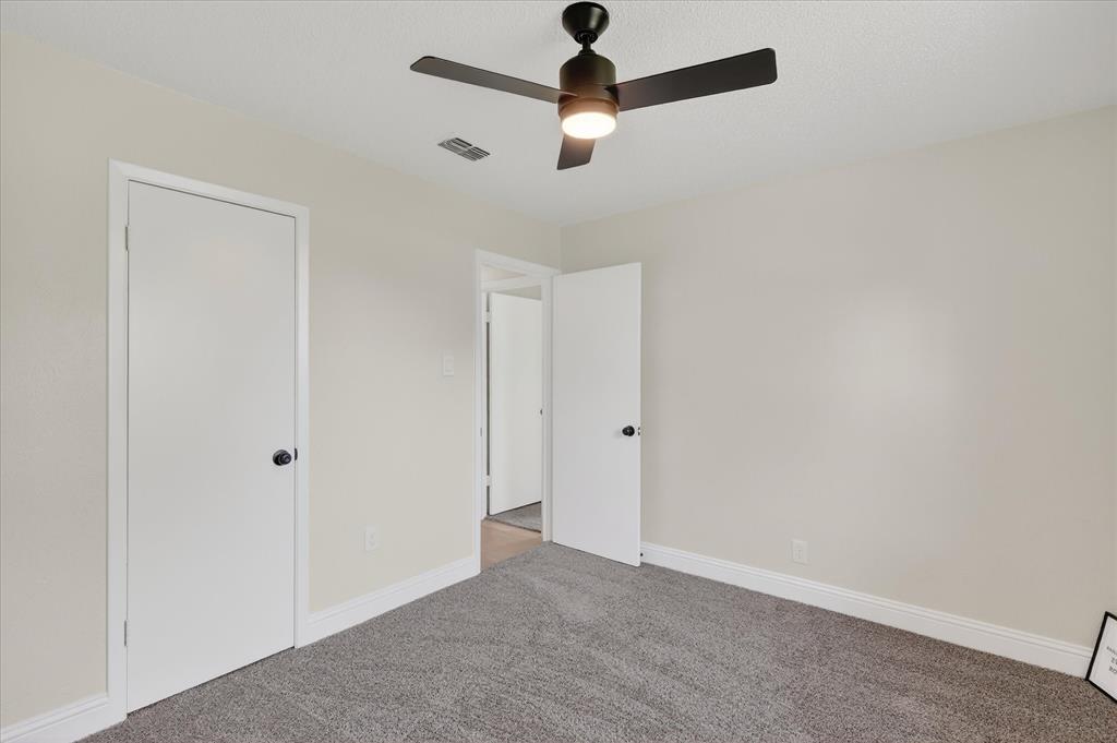 6425 Summit Ridge Drive Watauga, TX 76148 - Photo 13 of 18 Secondary bedroom. New baseboards, carpet, and fan