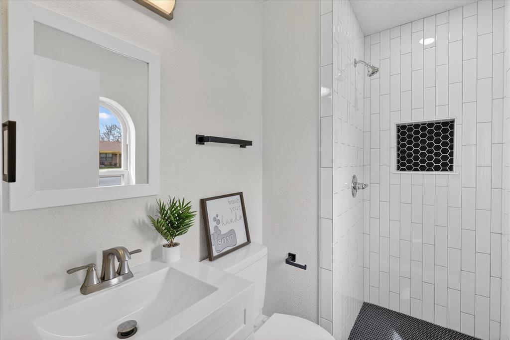 6425 Summit Ridge Drive Watauga, TX 76148 - Photo 15 of 18 Primary bathroom. Fully updated,everything is new. Penny tiles in shower floor and subway tile
