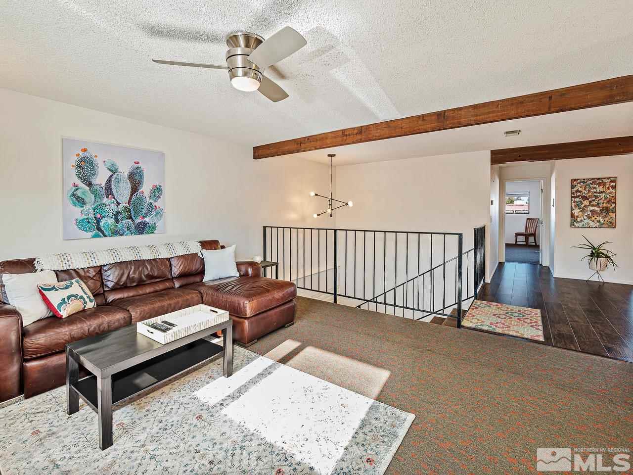 3447 Skyline Boulevard Reno, NV 89509 - Photo 12 of 24 a living room with furniture ceiling fan and a rug