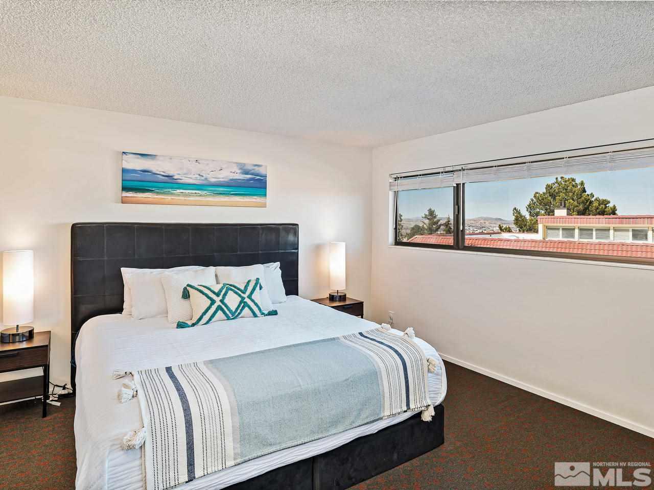 3447 Skyline Boulevard Reno, NV 89509 - Photo 14 of 24 a bedroom with a bed and a painting on the wall