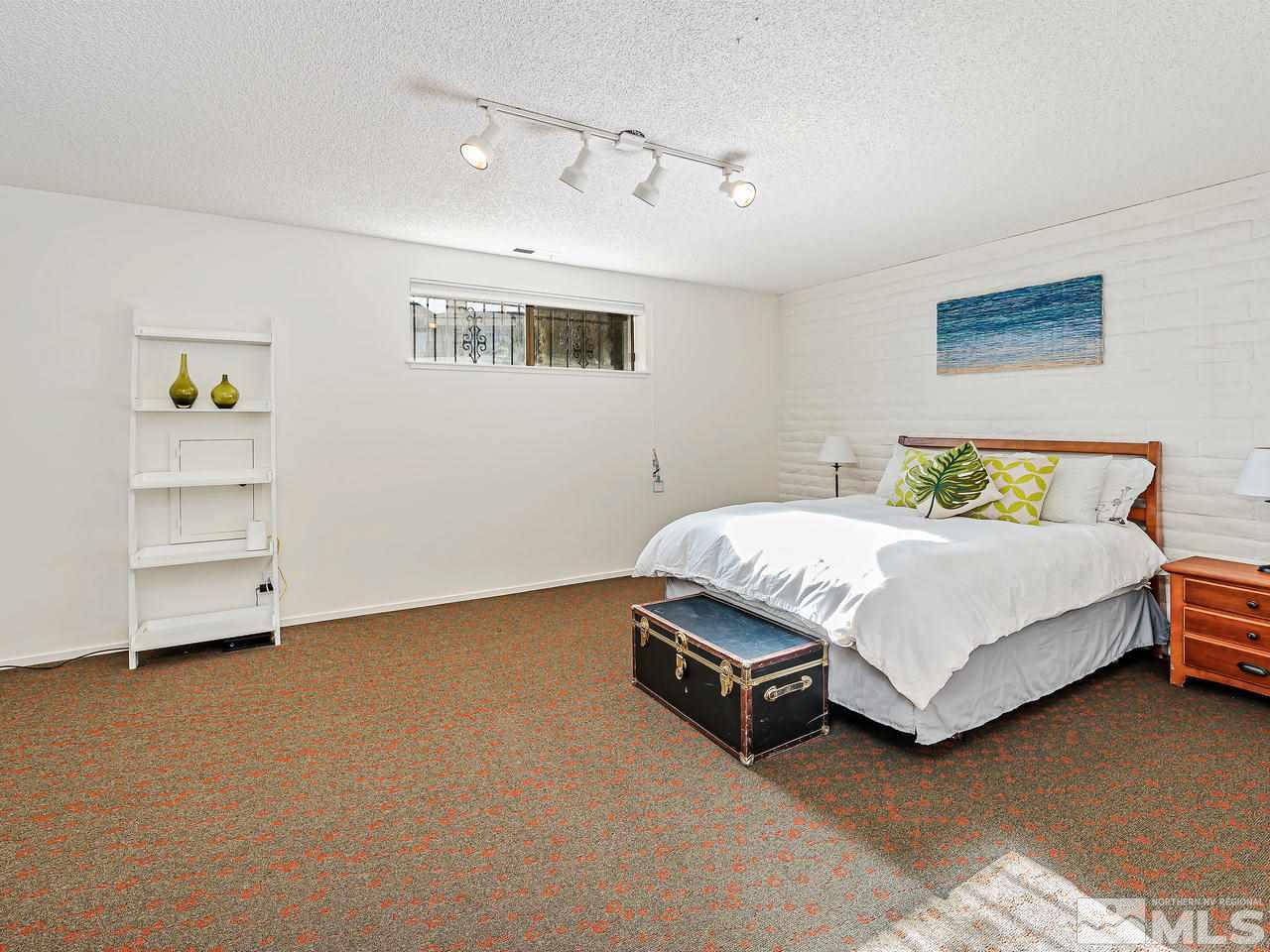 3447 Skyline Boulevard Reno, NV 89509 - Photo 20 of 24 a bedroom with a bed and a cabinets