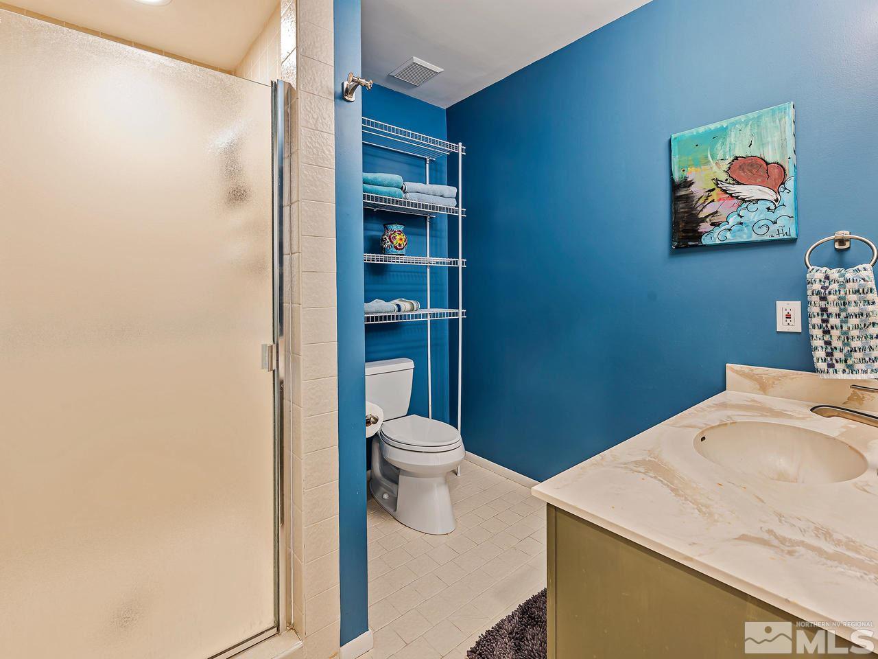 3447 Skyline Boulevard Reno, NV 89509 - Photo 21 of 24 a bathroom with a toilet a sink and mirror