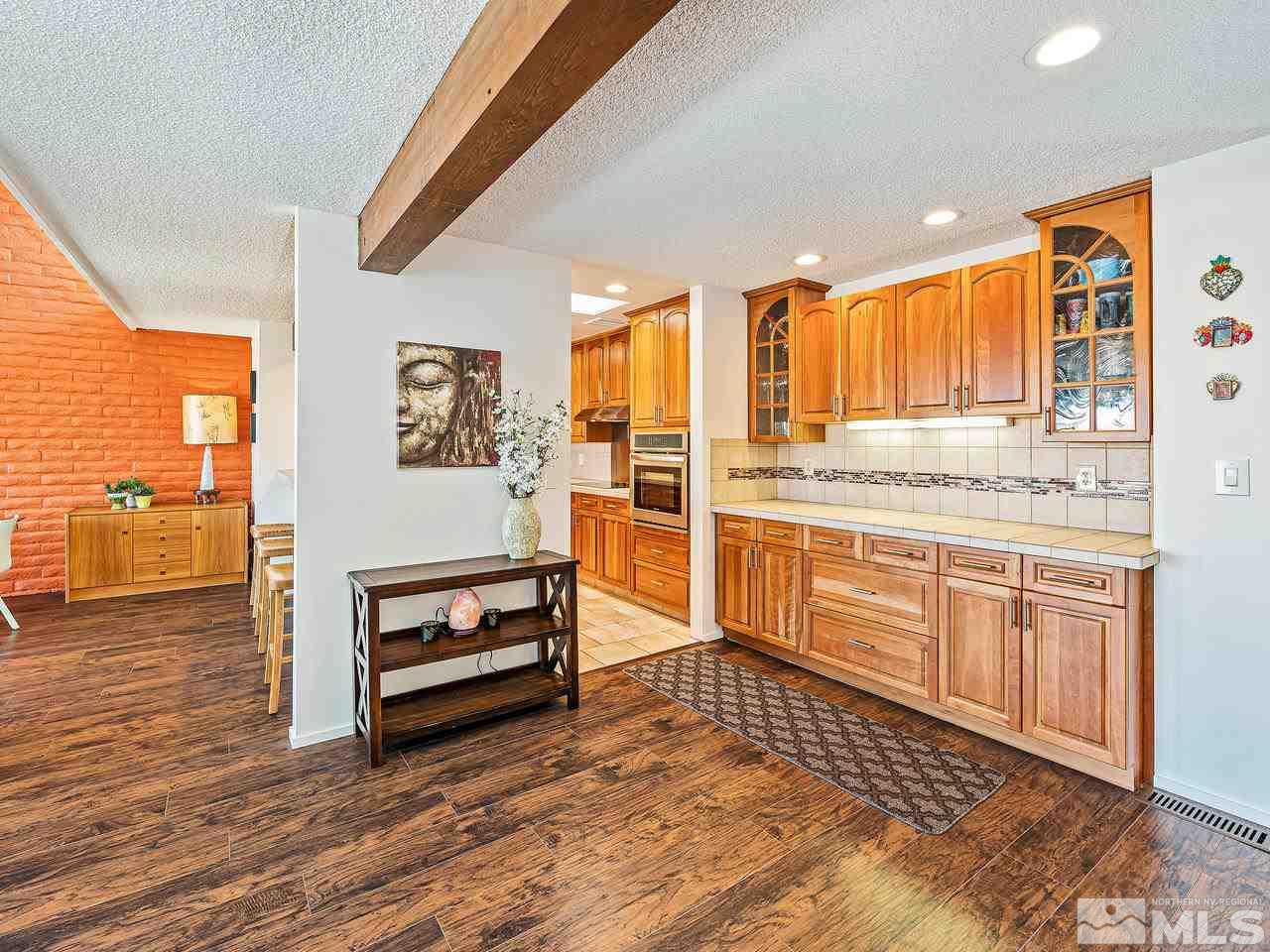 3447 Skyline Boulevard Reno, NV 89509 - Photo 3 of 24 a living room with stainless steel appliances granite countertop a refrigerator and cabinets