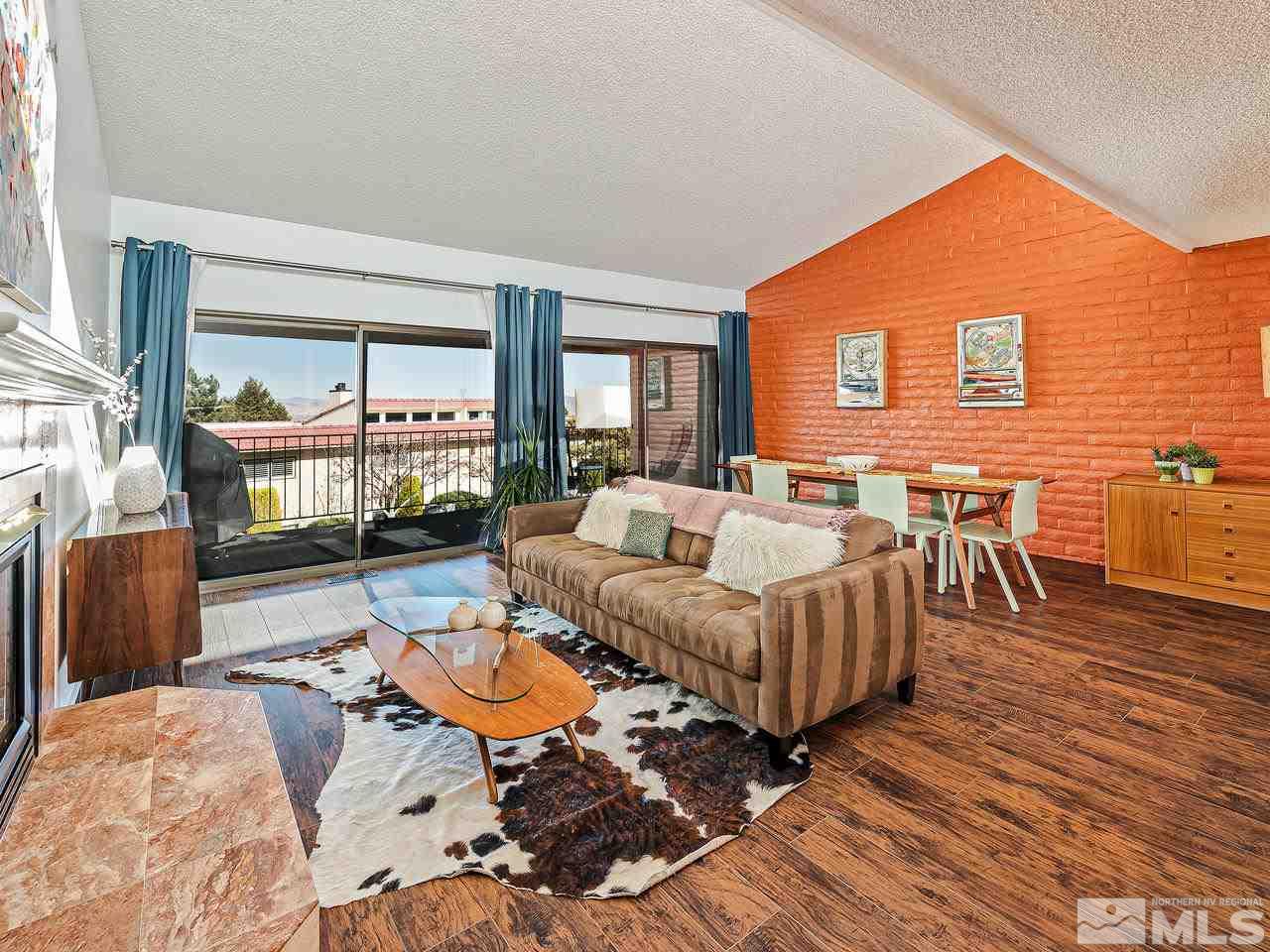 3447 Skyline Boulevard Reno, NV 89509 - Photo 4 of 24 a living room with furniture wooden floor and a table
