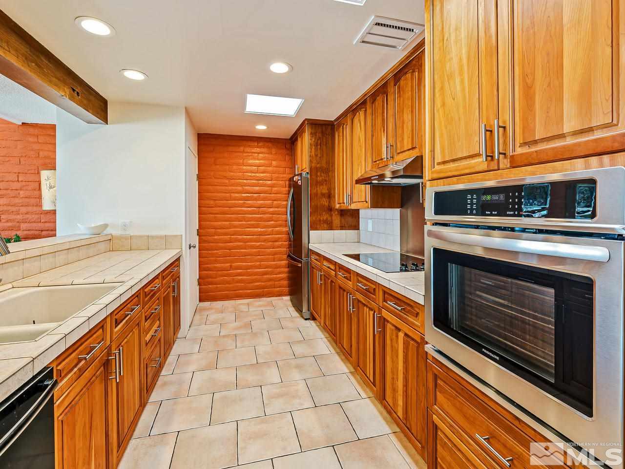 3447 Skyline Boulevard Reno, NV 89509 - Photo 8 of 24 a kitchen with stainless steel appliances granite countertop a stove and a sink