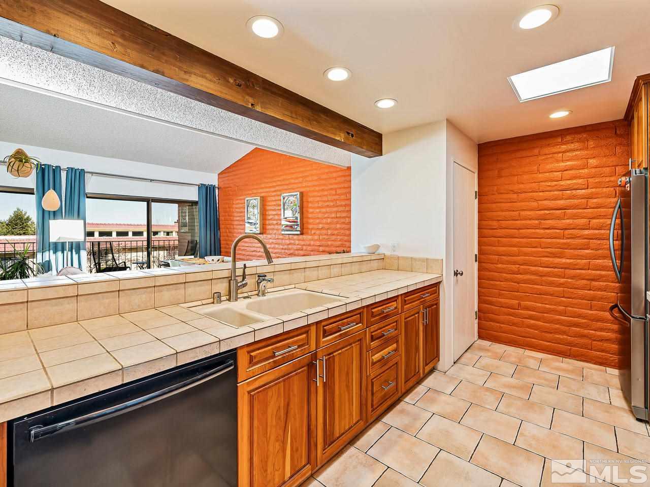 3447 Skyline Boulevard Reno, NV 89509 - Photo 9 of 24 a kitchen with stainless steel appliances a sink stove and cabinets