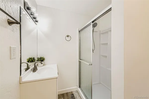 a bathroom with a sink a mirror and a shower