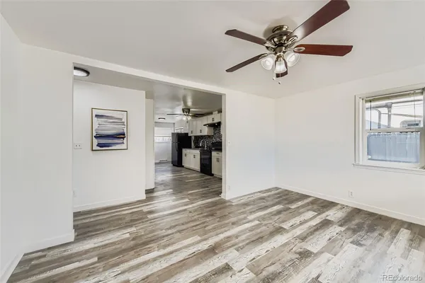 a view of empty room with wooden floor