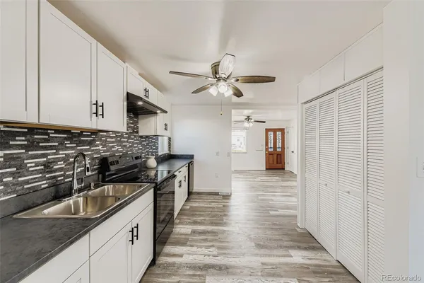 a kitchen with stainless steel appliances granite countertop a sink and cabinets