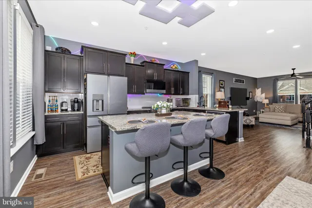a kitchen with granite countertop a sink stove and refrigerator