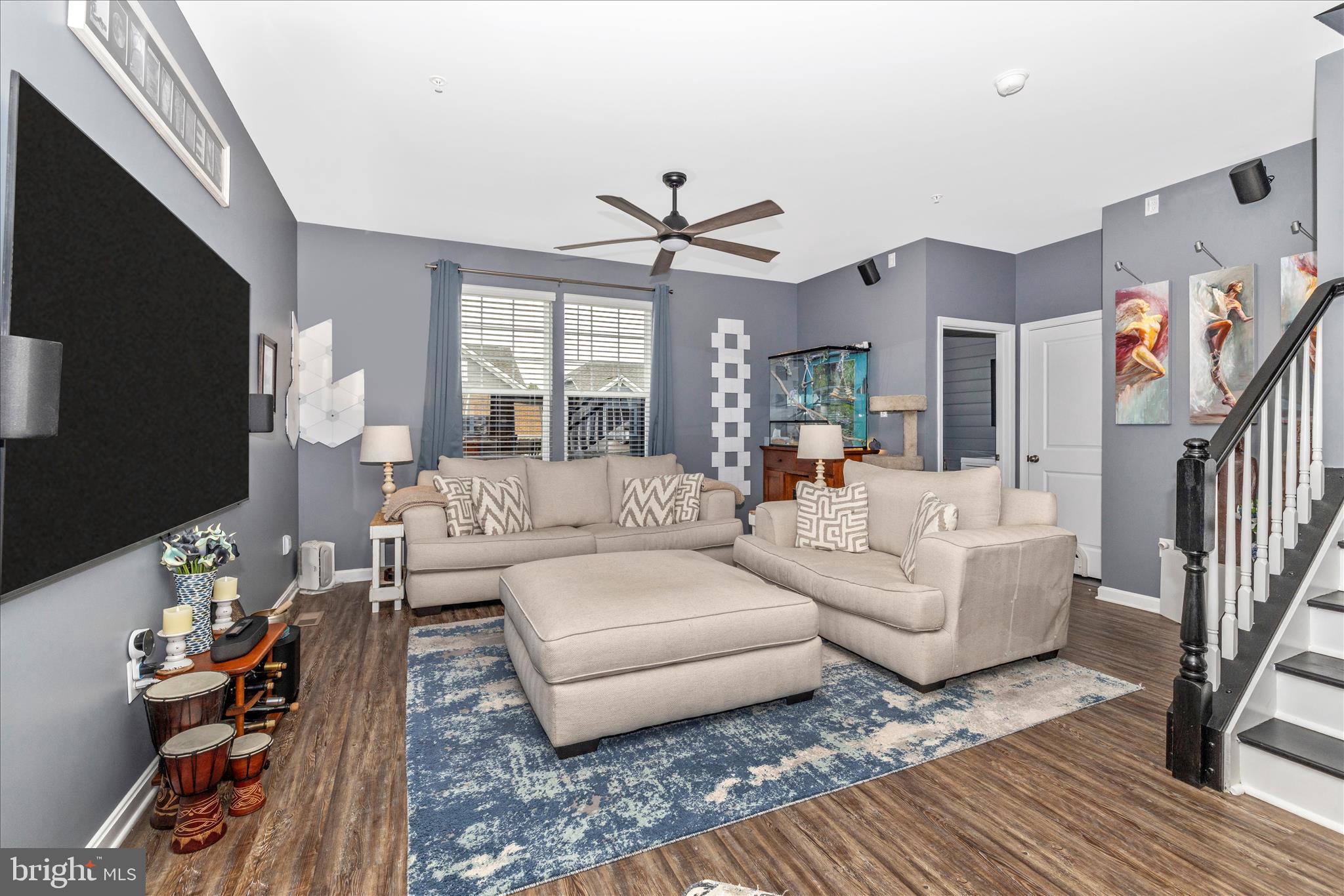 7001 Freedom Way Frederick, MD 21703 - Photo 22 of 65 a living room with furniture a ceiling fan and a flat screen tv