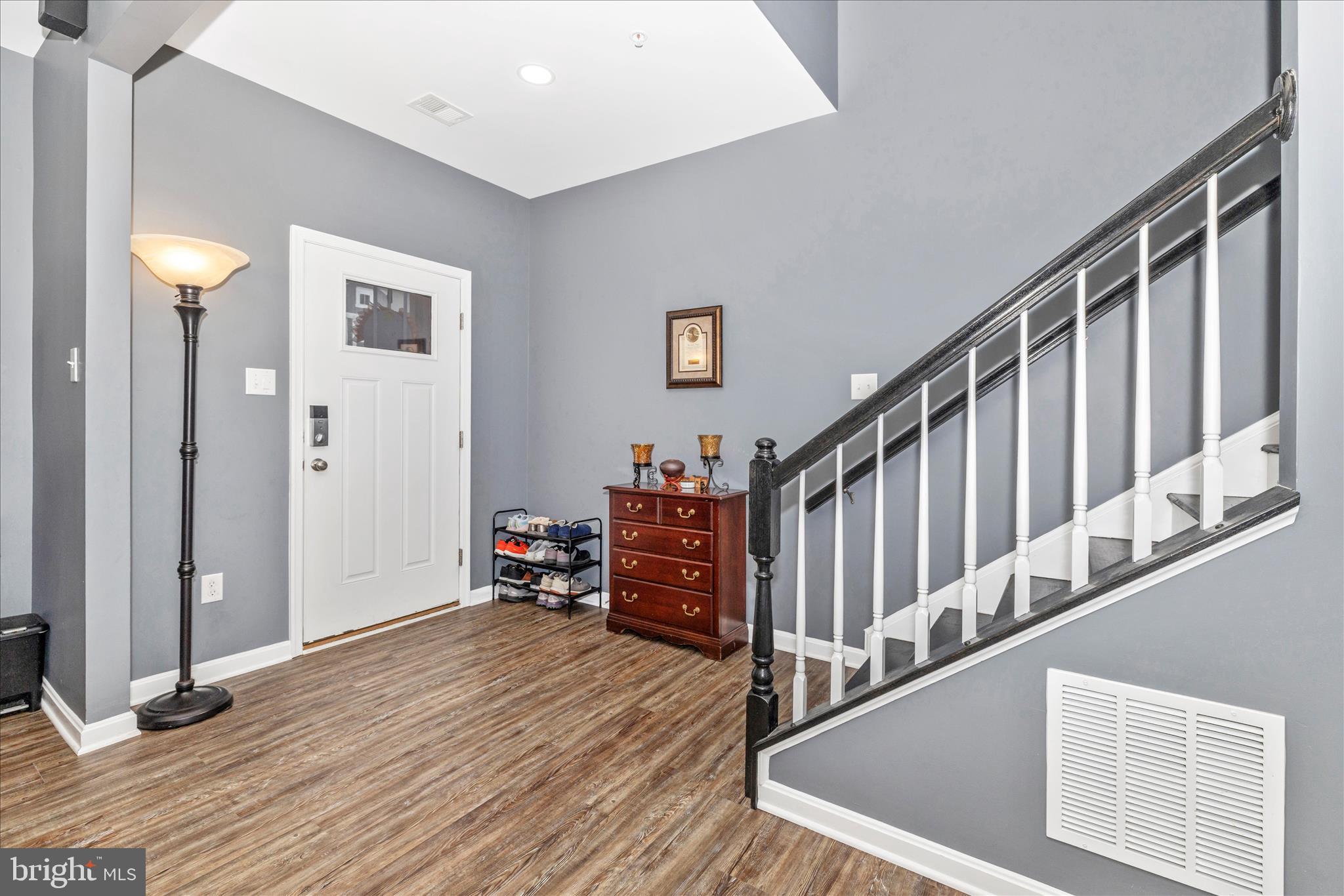 7001 Freedom Way Frederick, MD 21703 - Photo 3 of 65 a view of a hallway with wooden floor and stairs