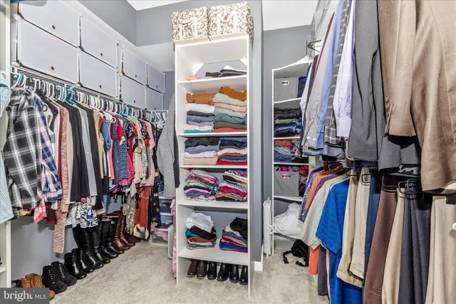 a bedroom with a large bed and a closet