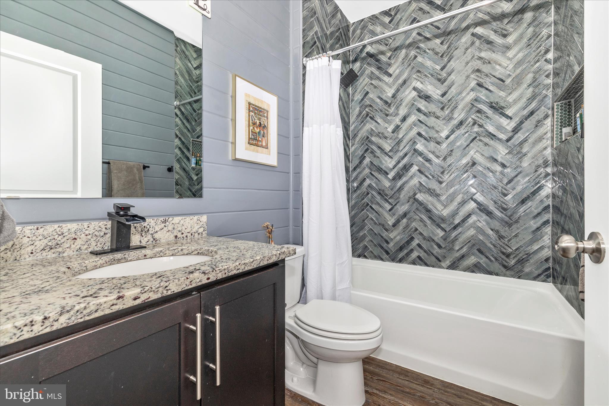 7001 Freedom Way Frederick, MD 21703 - Photo 38 of 65 a bathroom with a granite countertop bathtub sink vanity mirror and toilet