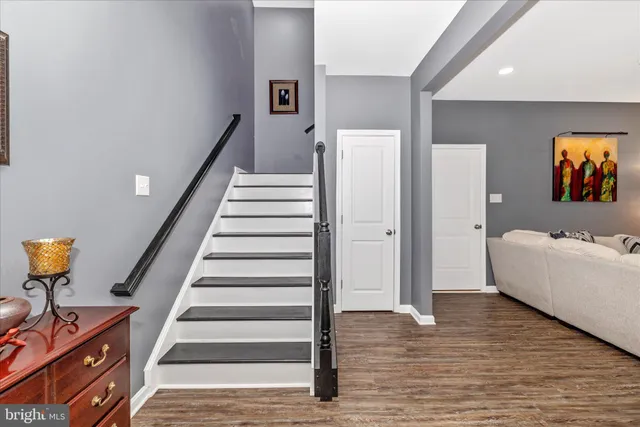 a view of entryway and hall with wooden floor
