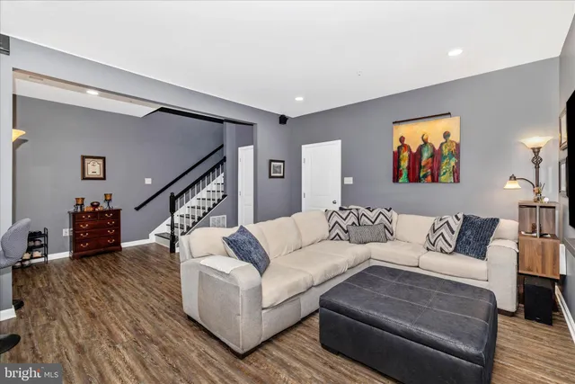 a living room with furniture and a painting on the wall