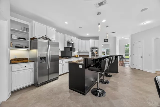 a bedroom with a bed and a view of kitchen